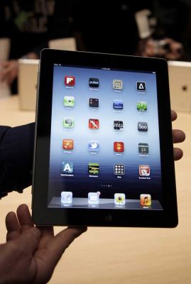 An Associated Press reporter holds up the new